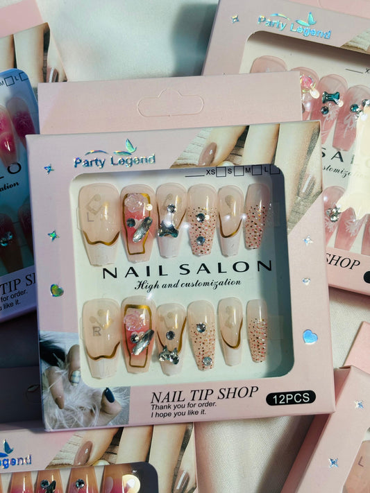 Amora Premium Press-On Fake Nails set box front view
Close-up of press-on nails decorative designs in packaging
Press-on nails box with pink border and branding visible
Display of nail tips floral & rhinestone designs in set
Press-on nails packaging on light background showing full set
Box of artificial nail tips with bold designs close-up
Press-on nail set styled in packaging “Nail Salon” view