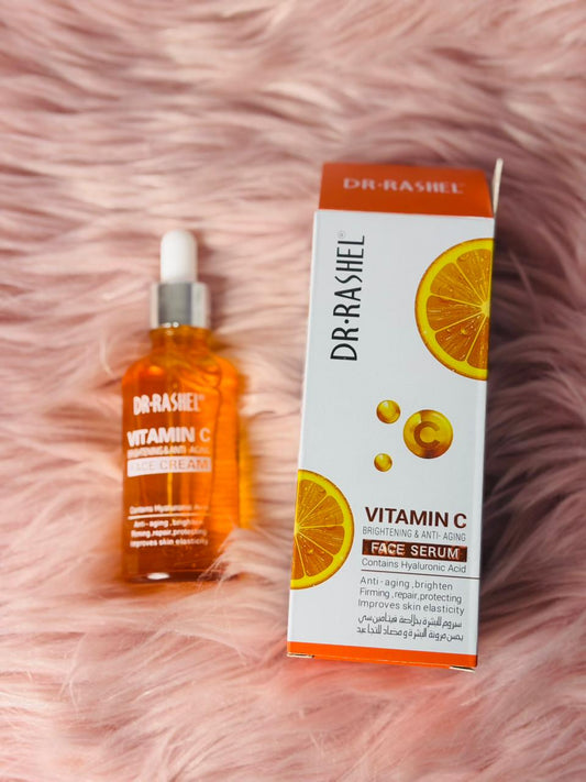 Dr Rashel Vitamin C Brightening and Anti-Aging Face Serum with Hyaluronic Acid placed beside packaging on soft pink background — perfect skincare product to help you discover radiant skin, improve elasticity, and achieve a glowing complexion.