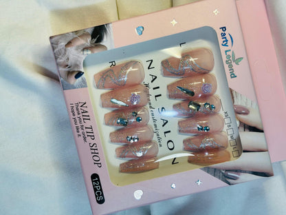 Amora Premium Press-On Fake Nails set box front view

Close-up of press-on nails decorative designs in packaging

Press-on nails box with pink border and branding visible

Display of nail tips floral & rhinestone designs in set

Press-on nails packaging on light background showing full set

Box of artificial nail tips with bold designs close-up

Press-on nail set styled in packaging “Nail Salon” view