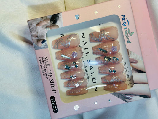 Amora Premium Press-On Fake Nails set box front view

Close-up of press-on nails decorative designs in packaging

Press-on nails box with pink border and branding visible

Display of nail tips floral & rhinestone designs in set

Press-on nails packaging on light background showing full set

Box of artificial nail tips with bold designs close-up

Press-on nail set styled in packaging “Nail Salon” view