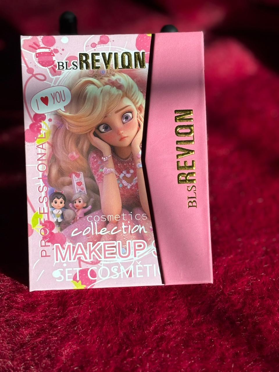 A pink BLs Revlon Princess Makeup Collection box featuring a cartoon princess design, placed on a bright red furry background.