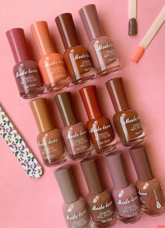  “Mode Love Vitamin Nail Polish” bottles in soft peach, nude, brown, and greyish tones placed aesthetically on a pink background.
