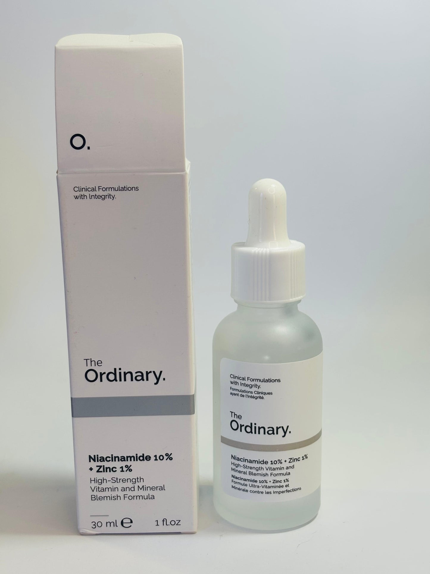 The Ordinary Niacinamide 30ml bottle front view

Close-up of Niacinamide Serum dropper with liquid

The Ordinary Niacinamide 10% + Zinc 1% packaging box with bottle

Bottle lying flat on light background with label visible

Lifestyle shot: serum bottle on vanity with plants or minimal decor

Texture close-up: drop of Niacinamide serum on hand or surface