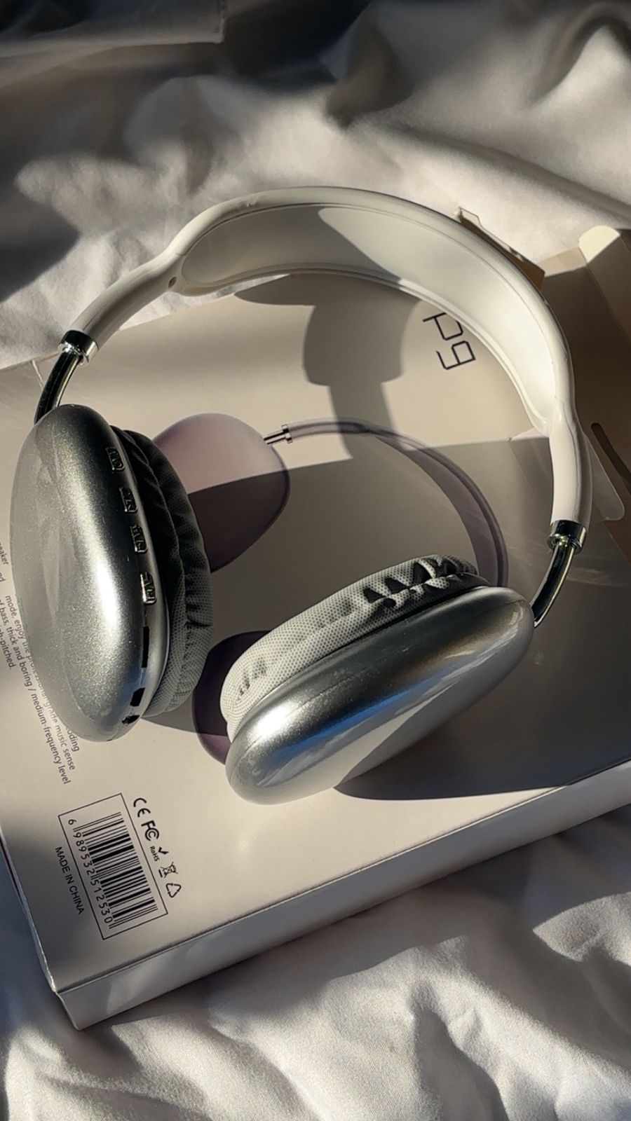 Silver headphones on a white surface with a visible brand logo. P9 Wireless Bluetooth Headphones with Microphone – Noise Cancelling