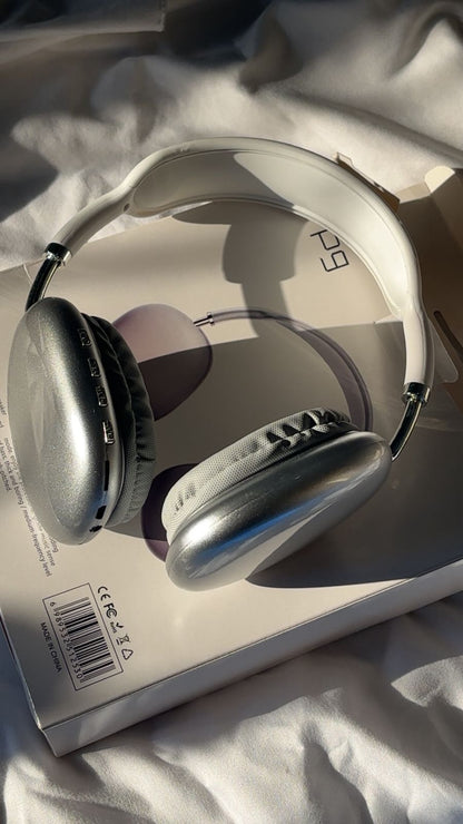 Silver headphones on a white surface with a visible brand logo. P9 Wireless Bluetooth Headphones with Microphone – Noise Cancelling