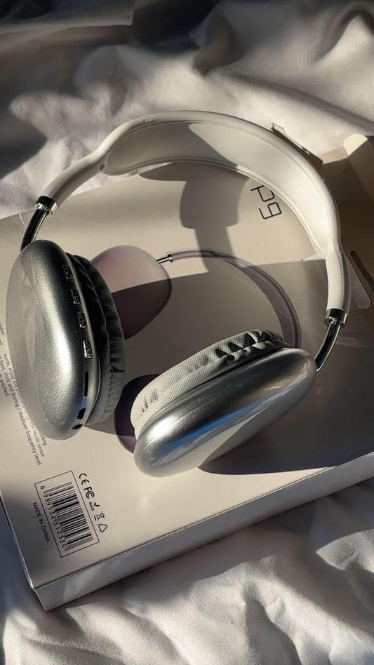 Silver headphones on a white surface with a visible brand logo. P9 Wireless Bluetooth Headphones with Microphone – Noise Cancelling