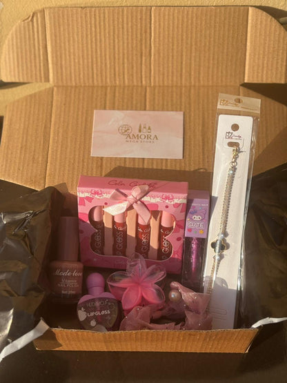 Top-angle view of a Pink Beauty Surprise Box containing assorted pink makeup products and accessories neatly arranged.