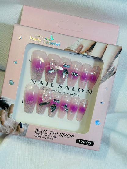 Amora Premium Press-On Fake Nails set box front view

Close-up of press-on nails decorative designs in packaging

Press-on nails box with pink border and branding visible

Display of nail tips floral & rhinestone designs in set

Press-on nails packaging on light background showing full set

Box of artificial nail tips with bold designs close-up

Press-on nail set styled in packaging “Nail Salon” view