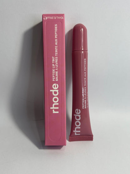Rhode Peptide Lip Tint in Salty Tan , warm beige nude lip tint with hydrating peptide formula.
Rhode Salty Tan lip tint , natural nude shade, smooth glossy finish with peptide care.