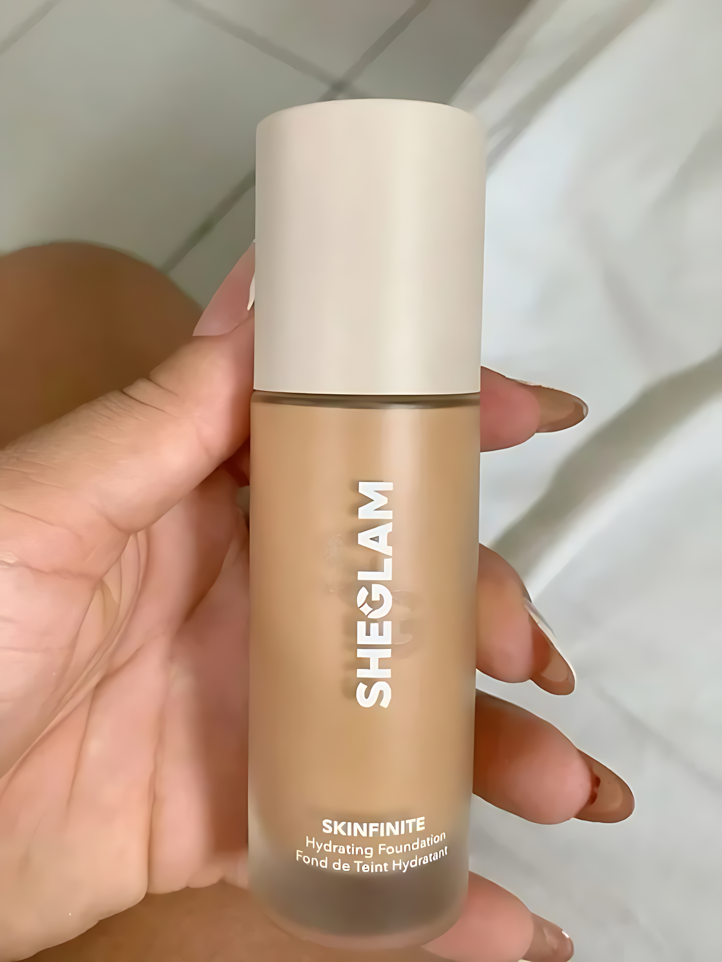 kinfinite Hydrating Foundation with Primer bottle close-up.