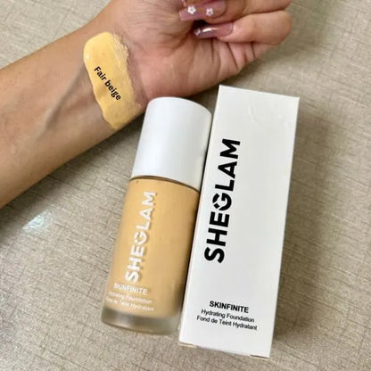 SHEGLAM foundation bottle and packaging on a textured surface
