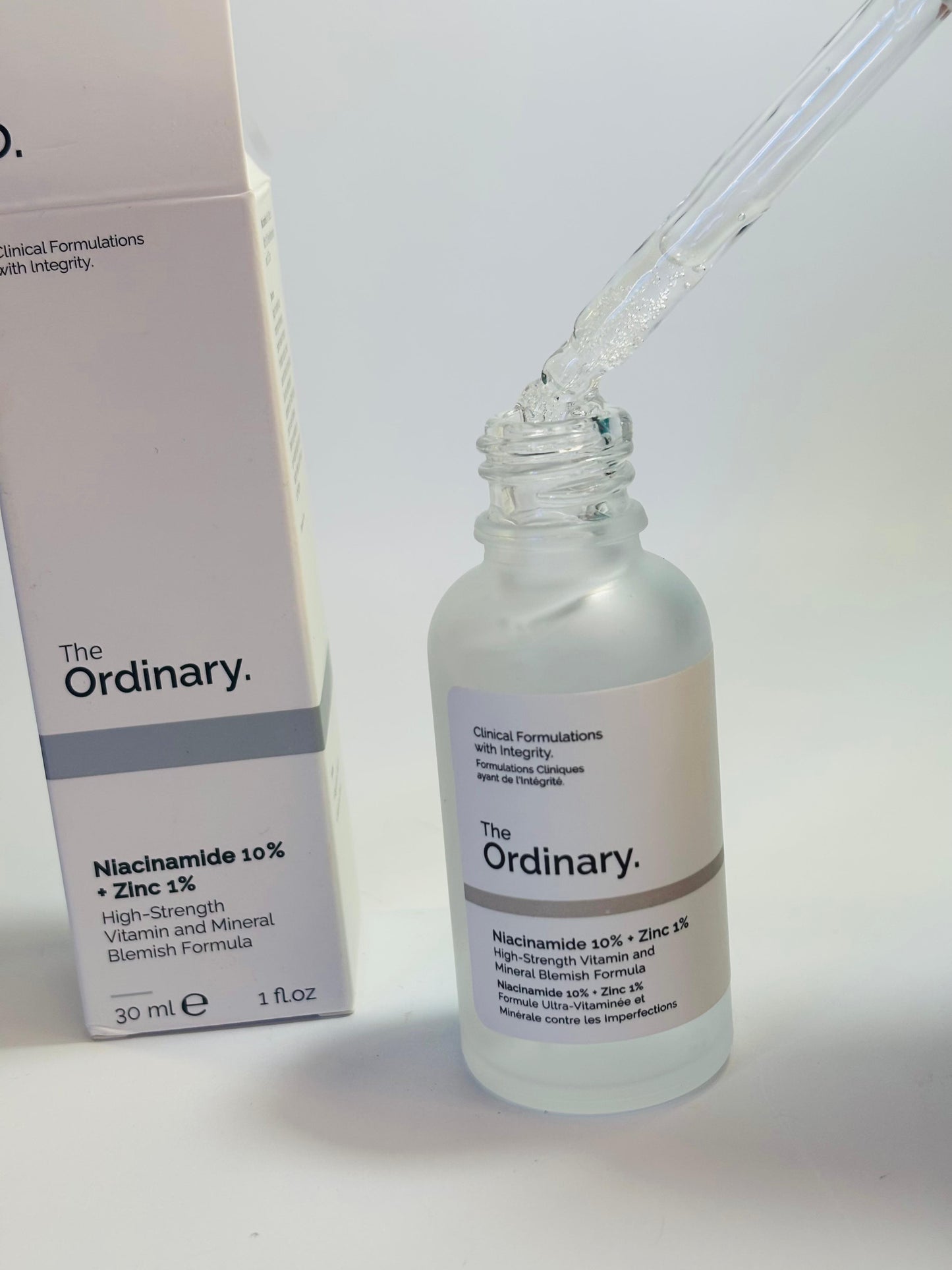 The Ordinary Niacinamide 30ml bottle front view

Close-up of Niacinamide Serum dropper with liquid

The Ordinary Niacinamide 10% + Zinc 1% packaging box with bottle

Bottle lying flat on light background with label visible

Lifestyle shot: serum bottle on vanity with plants or minimal decor

Texture close-up: drop of Niacinamide serum on hand or surface