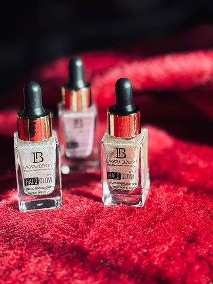 "Set of three illuminating serum dropper bottles placed on red fabric under natural light."
