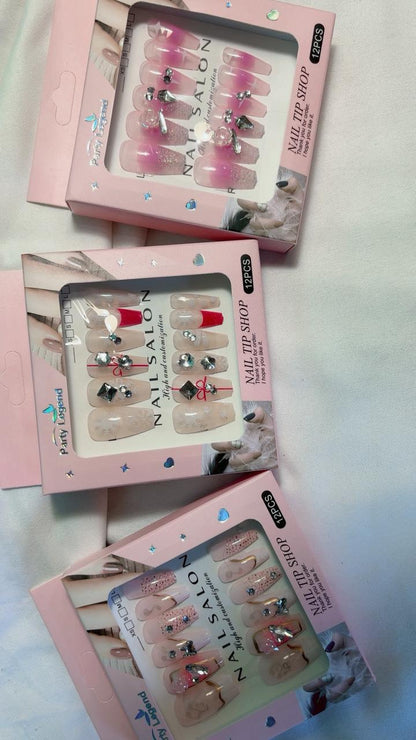 Amora Premium Press-On Fake Nails set box front view

Close-up of press-on nails decorative designs in packaging

Press-on nails box with pink border and branding visible

Display of nail tips floral & rhinestone designs in set

Press-on nails packaging on light background showing full set

Box of artificial nail tips with bold designs close-up

Press-on nail set styled in packaging “Nail Salon” view