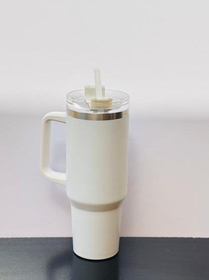 White matte insulated tumbler cup with a handle and clear straw placed on a clean, minimal background