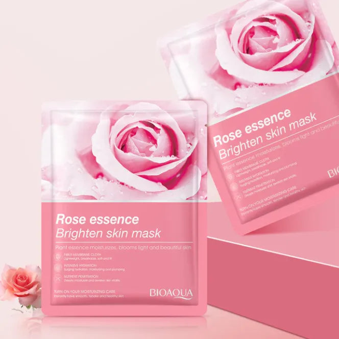 Rose essence brightening skin mask packaging with pink roses on a light pink background